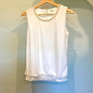 White top with pearls around the neck